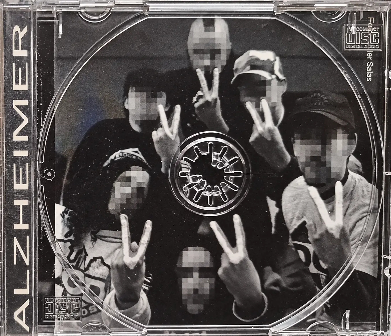 Inside the 1995 Alzheimer CD case by Def Con Dos, showing a band photograph behind the disc tray.